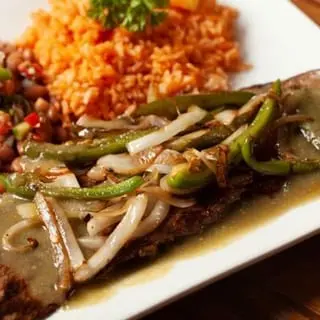 Carne Asada with grilled onions, peppers, and rice